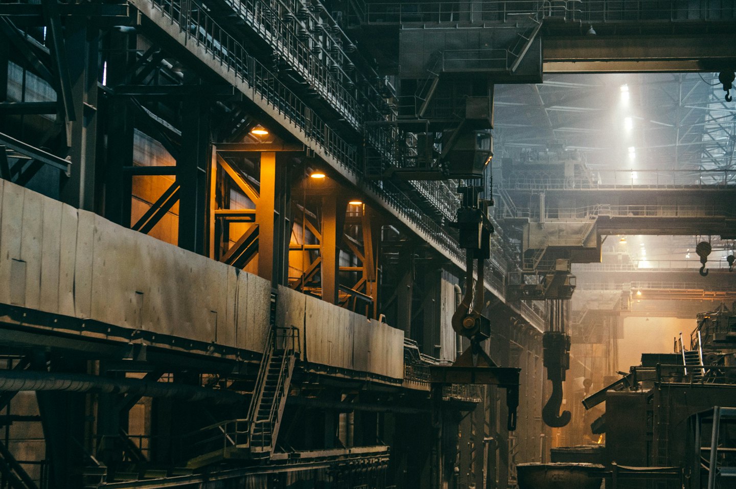 Factory interior with massive steel beams and overhead cranes.