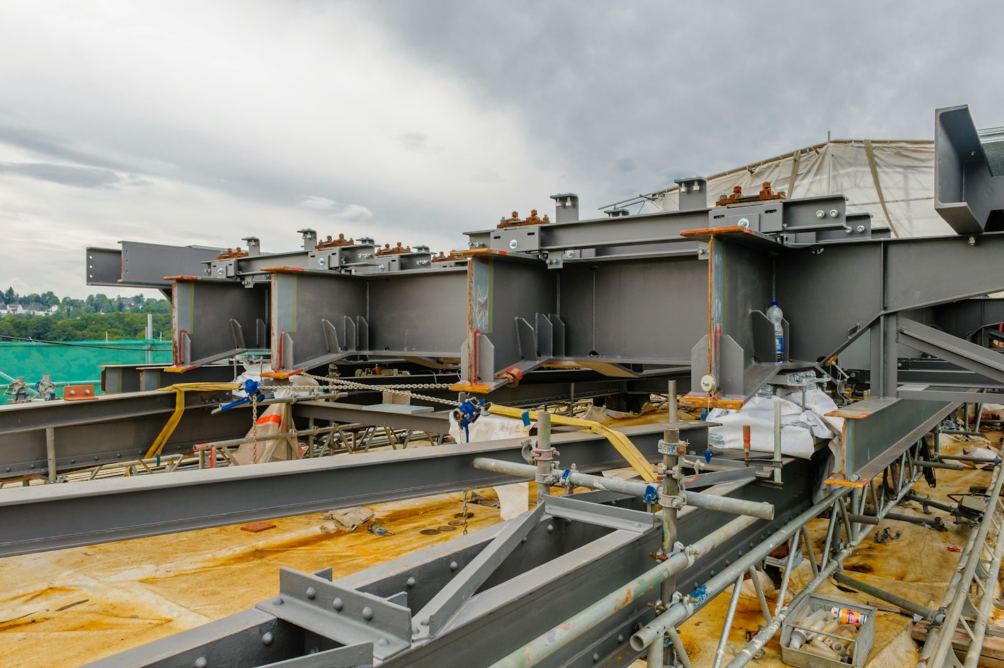Steel I-beams and scaffolding at a construction site.